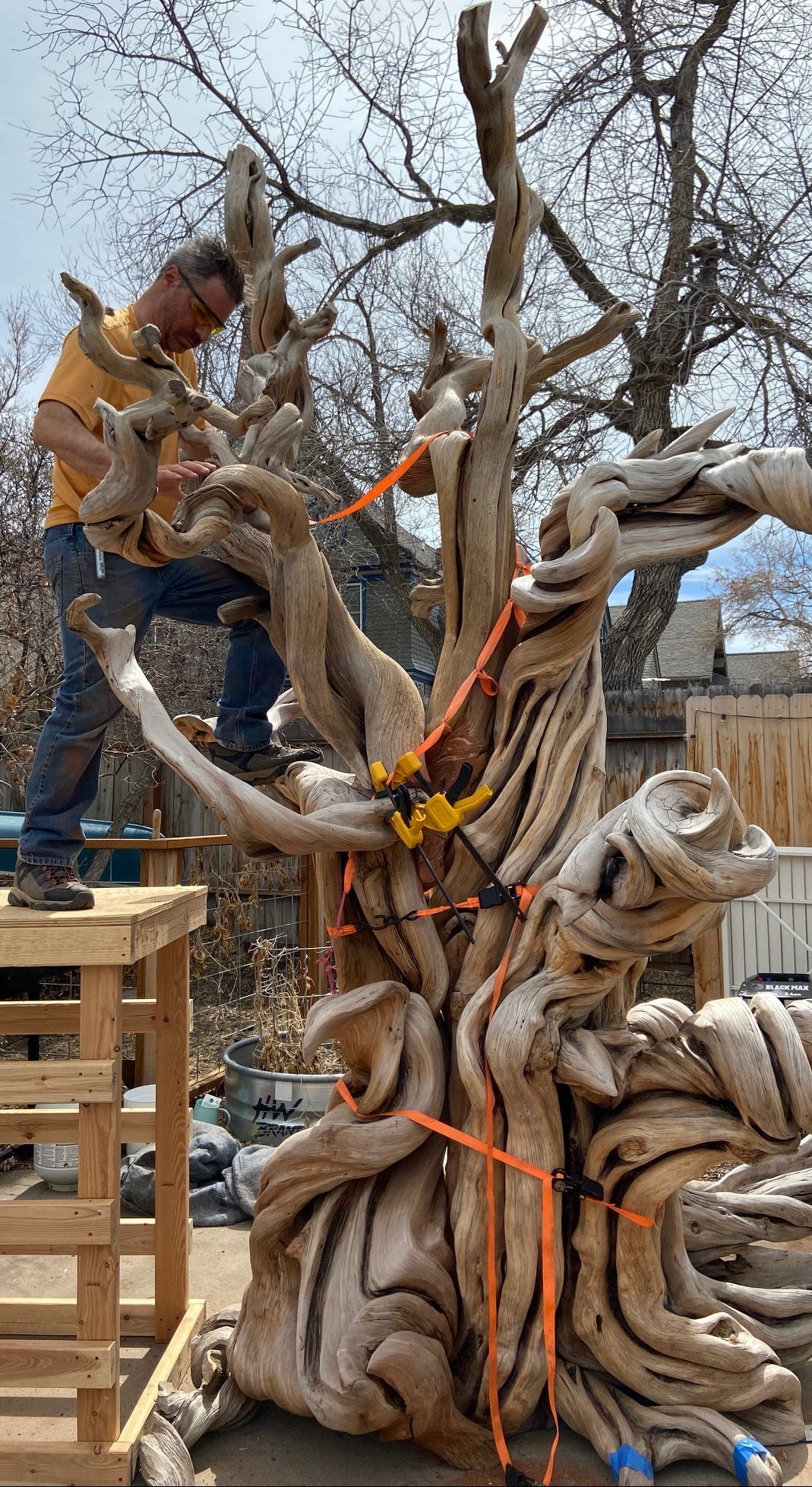 artist Tom Benedict works on the Manitou juniper outside his shop in montana